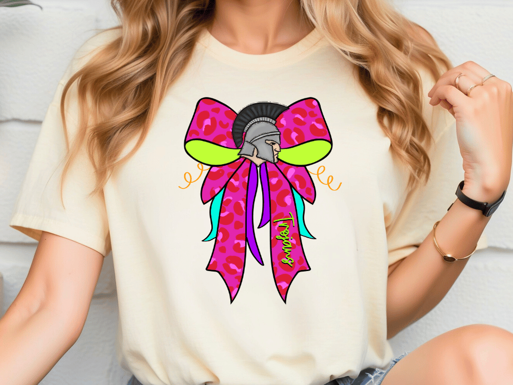 A woman wearing a white t-shirt with a colorful graphic design of a bow on it.