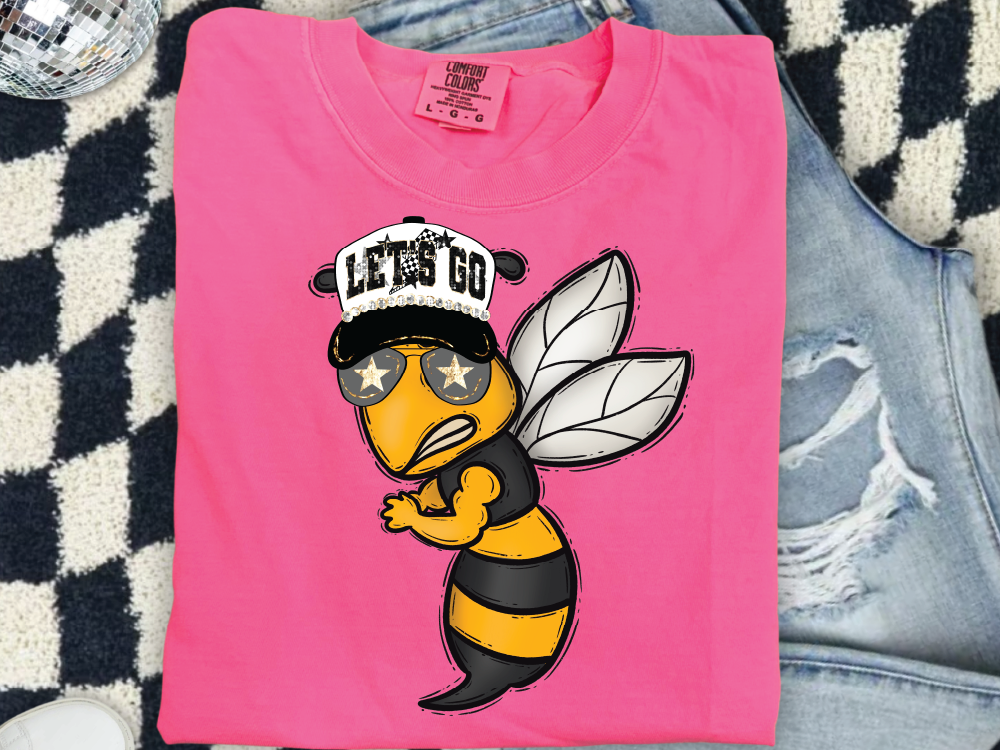 A pink t-shirt with a cartoon bee wearing a baseball cap and sunglasses, along with the text "LET'S GO" printed on it.