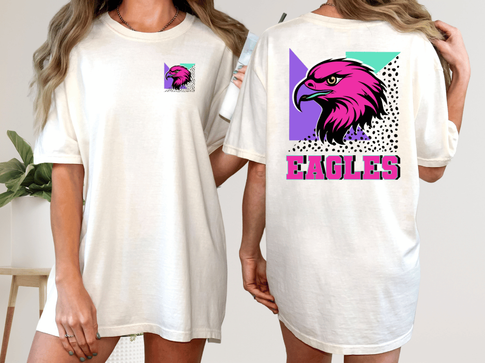 A woman wearing a white t-shirt with a graphic of a pink eagle and the word "EAGLES" printed on the back.
