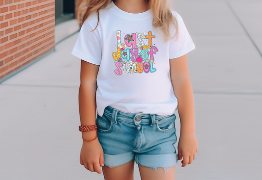 a little girl standing on a sidewalk wearing a white t - shirt