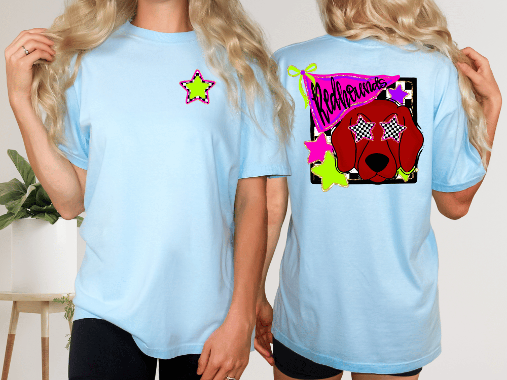 A woman wearing a light blue t-shirt with a graphic design on the back, including a red dog wearing sunglasses and a star.