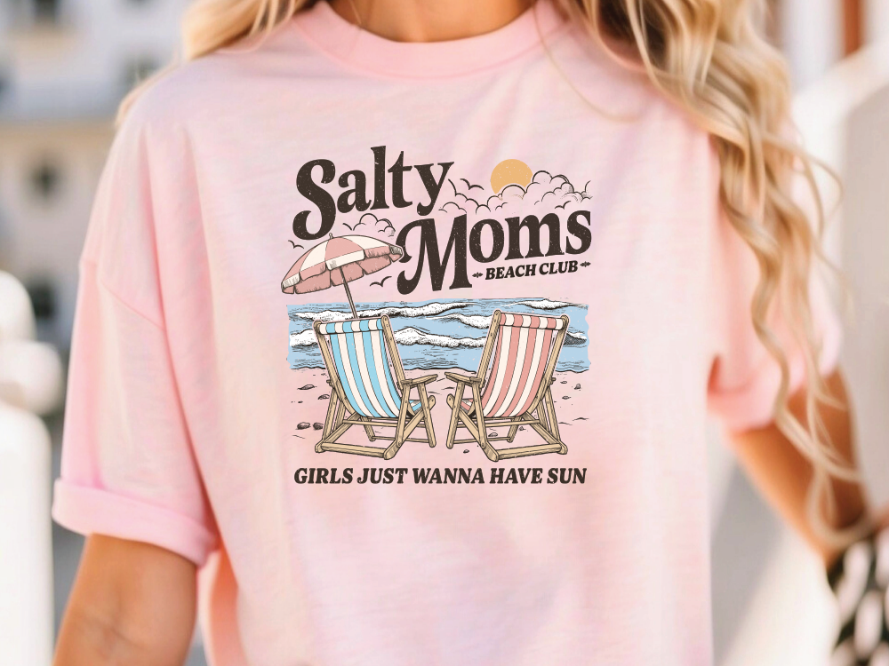 a woman wearing a pink shirt that says salty moms beach club
