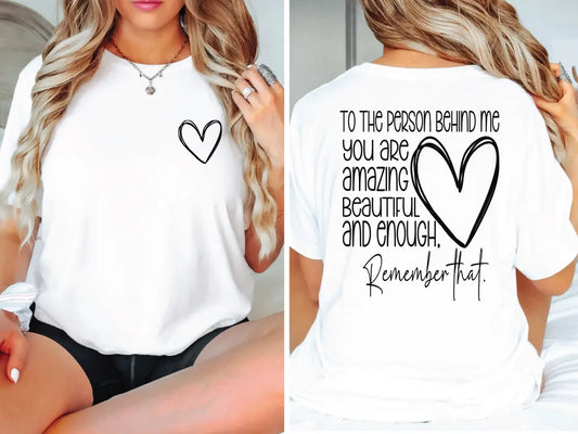 a woman wearing a white shirt with a heart on it