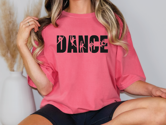 a woman wearing a pink shirt with the word dance on it
