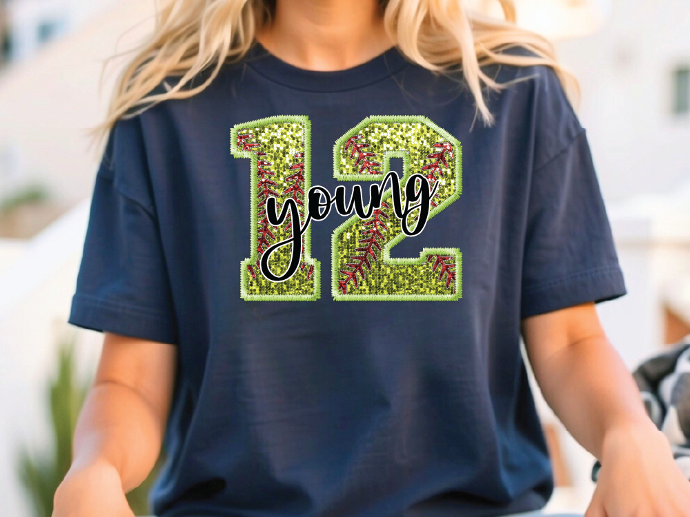 a young woman sitting on a skateboard wearing a t - shirt with the number