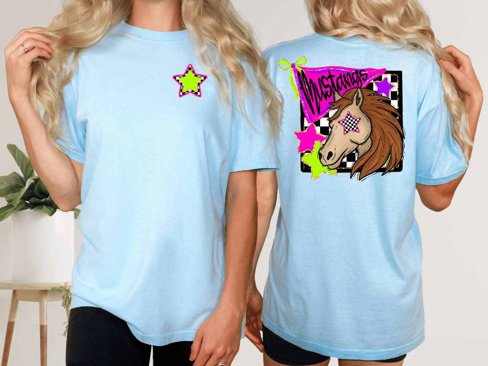 A woman wearing a light blue t-shirt with a graphic design on the back, including a horse and colorful stars.