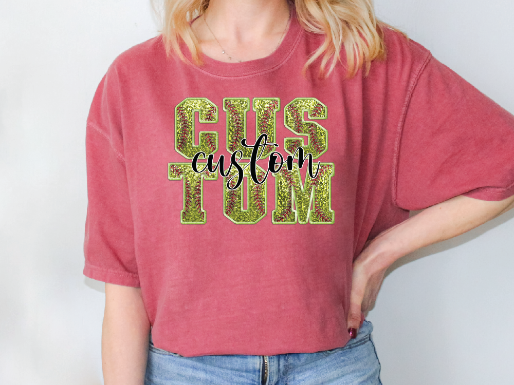 a woman wearing a pink shirt with green glitter letters
