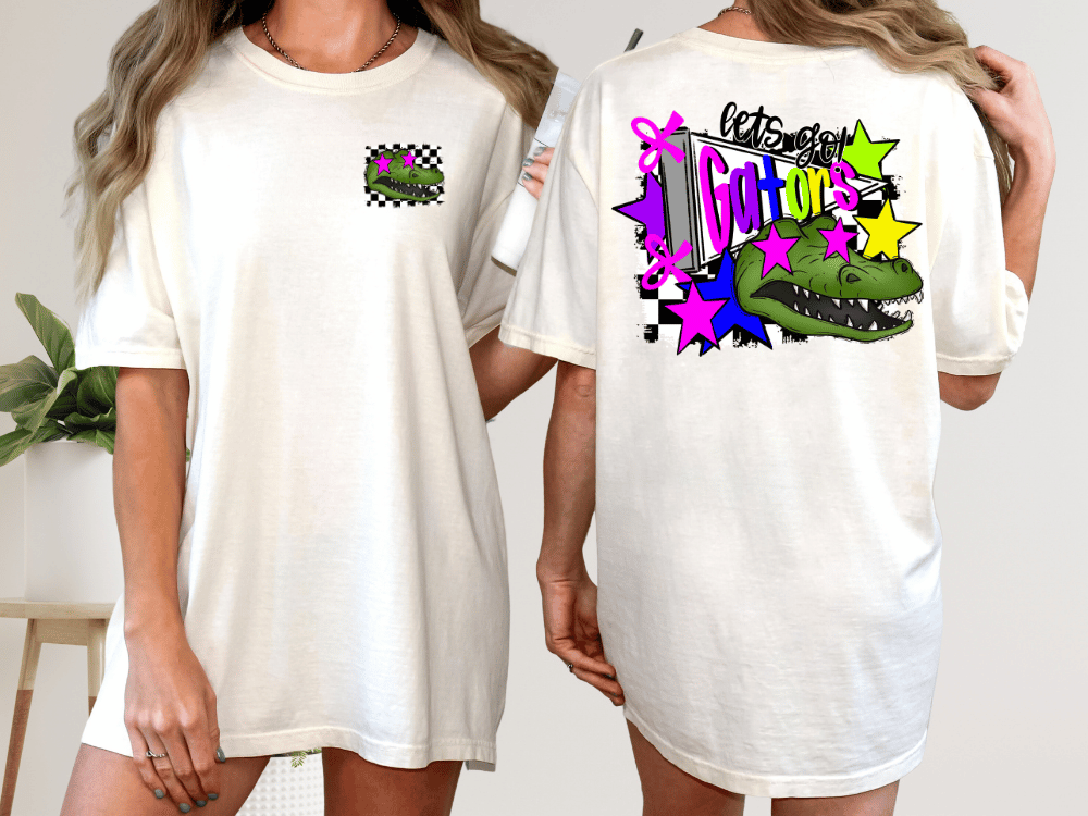 A white t-shirt with a graphic design on the back, featuring a green alligator and colorful stars.