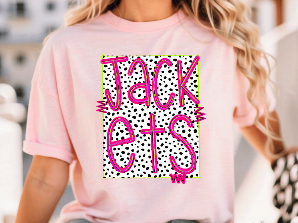 A woman wearing a pink t-shirt with a graphic design featuring the word "JACK" in pink and black text, surrounded by a pattern of black and white polka dots.