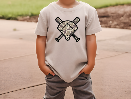 a young boy wearing a t - shirt with a baseball bat on it