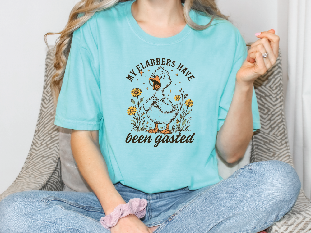 a woman sitting on a couch wearing a t - shirt