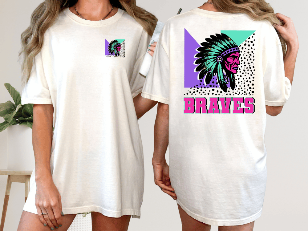 A woman wearing a white t-shirt with a colorful graphic design on the back, including a Native American headdress and the word "Braves" written below it.