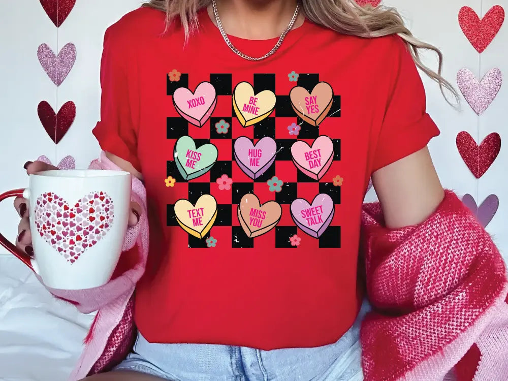 a woman in a red shirt holding a coffee mug