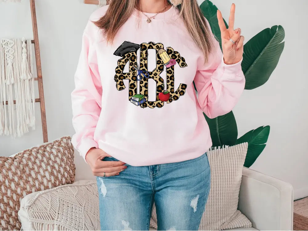 a woman wearing a pink sweatshirt with a leopard print on it