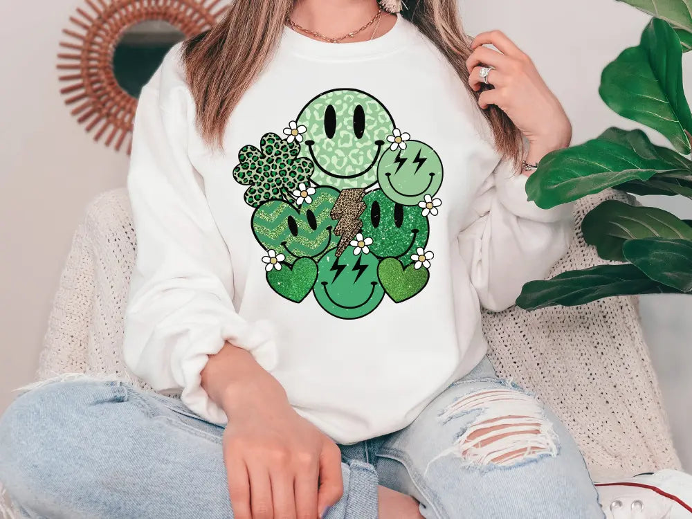 a woman sitting on a couch wearing a white shirt with a shamrock face on it
