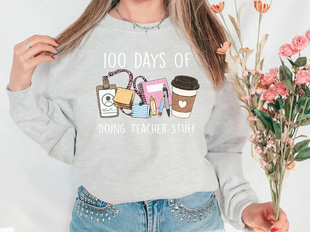 a woman wearing a sweatshirt that says 100 days of doing teacher stuff