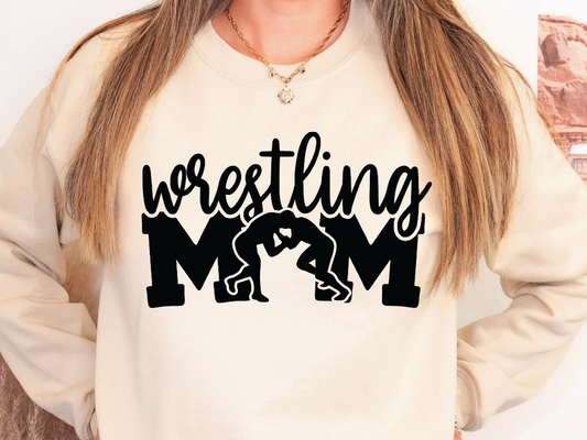 a woman wearing a sweatshirt that says wrestling mom
