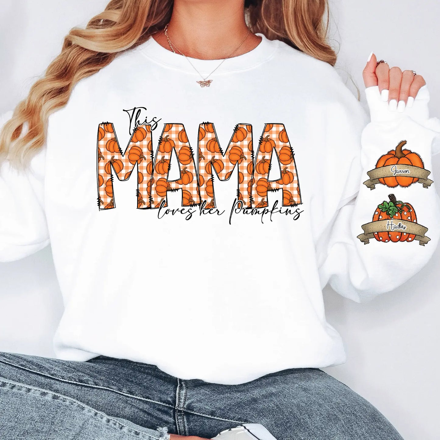 a woman wearing a white shirt with the word mama on it