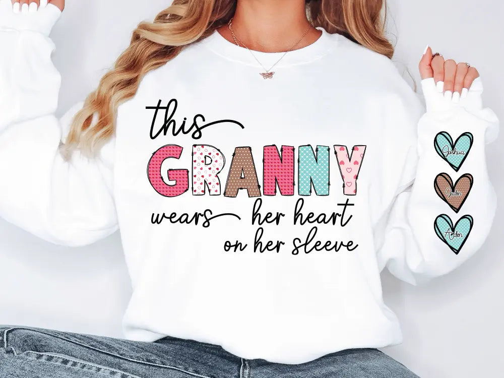 a woman wearing a white shirt that says granny wears her heart on her sleeve