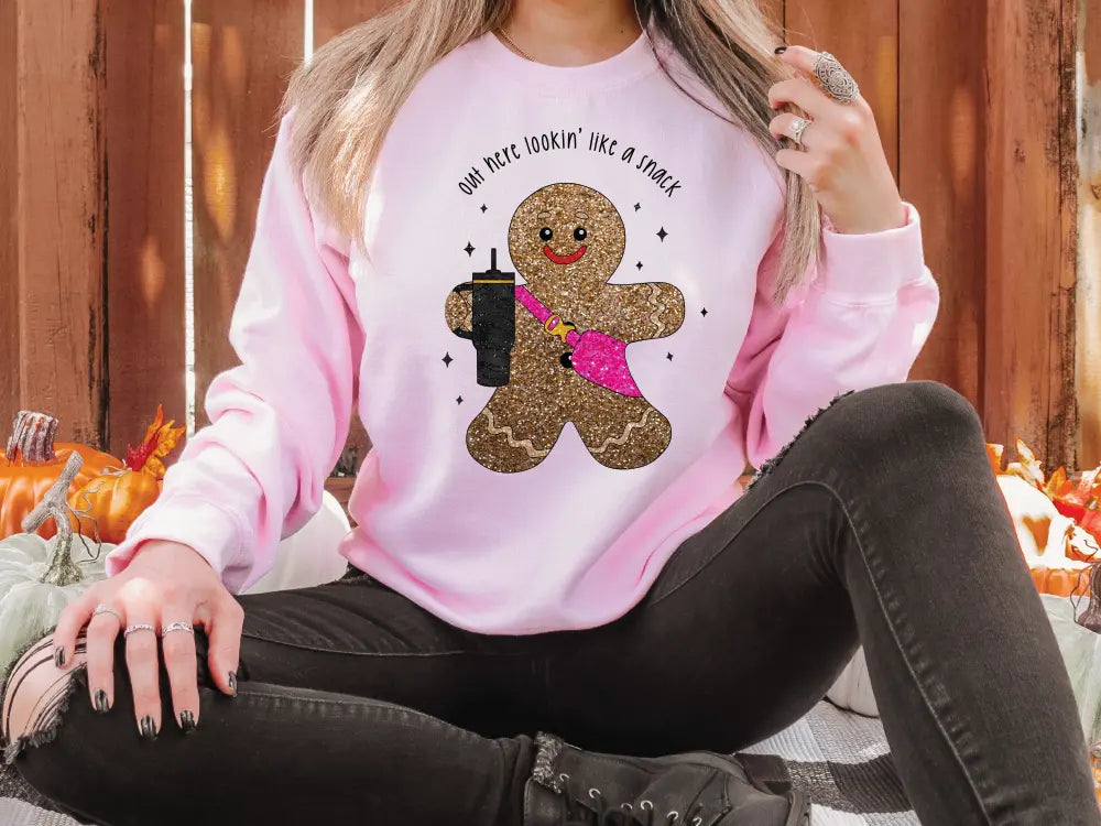 a woman sitting on the ground wearing a pink shirt with a teddy bear on it