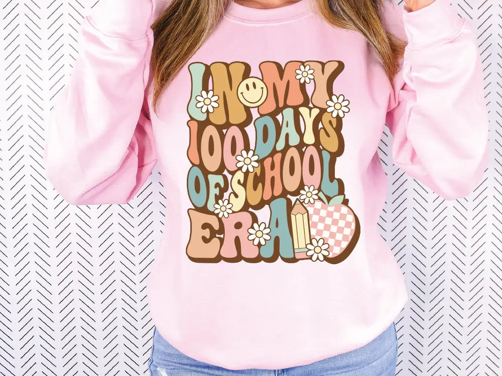 a woman wearing a pink sweatshirt with a long sleeve