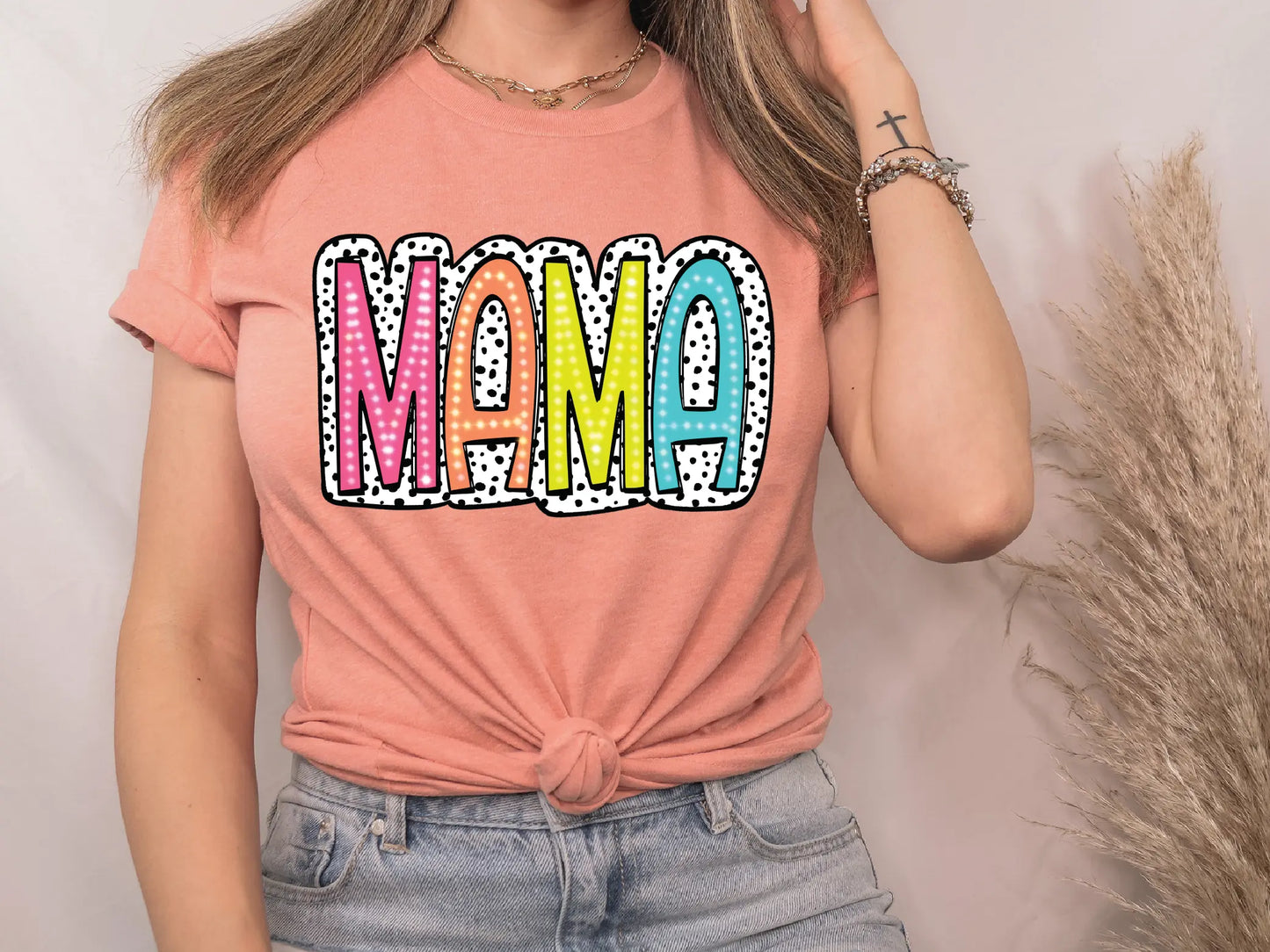 a woman in a pink shirt is talking on a cell phone