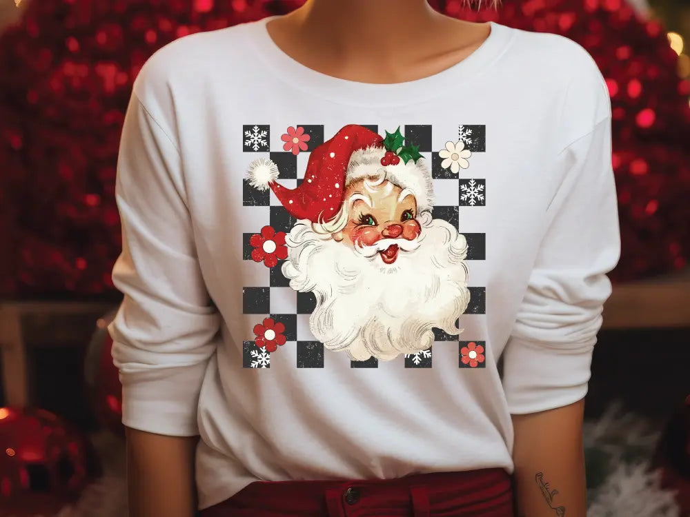 a woman wearing a santa clause shirt in front of a christmas tree