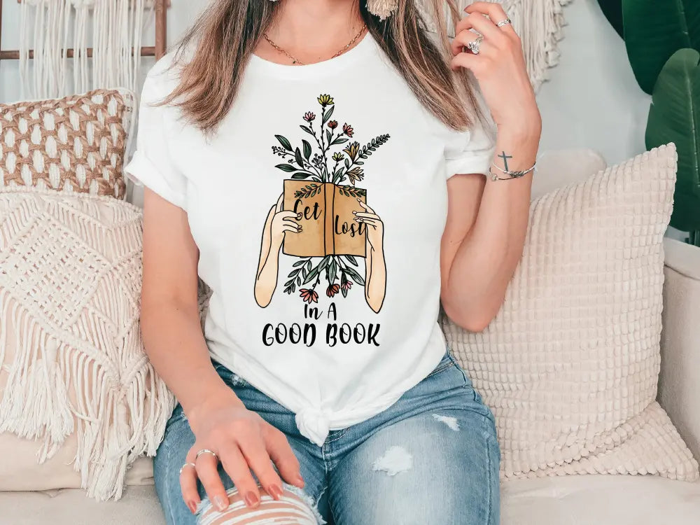 a woman sitting on a couch holding a book
