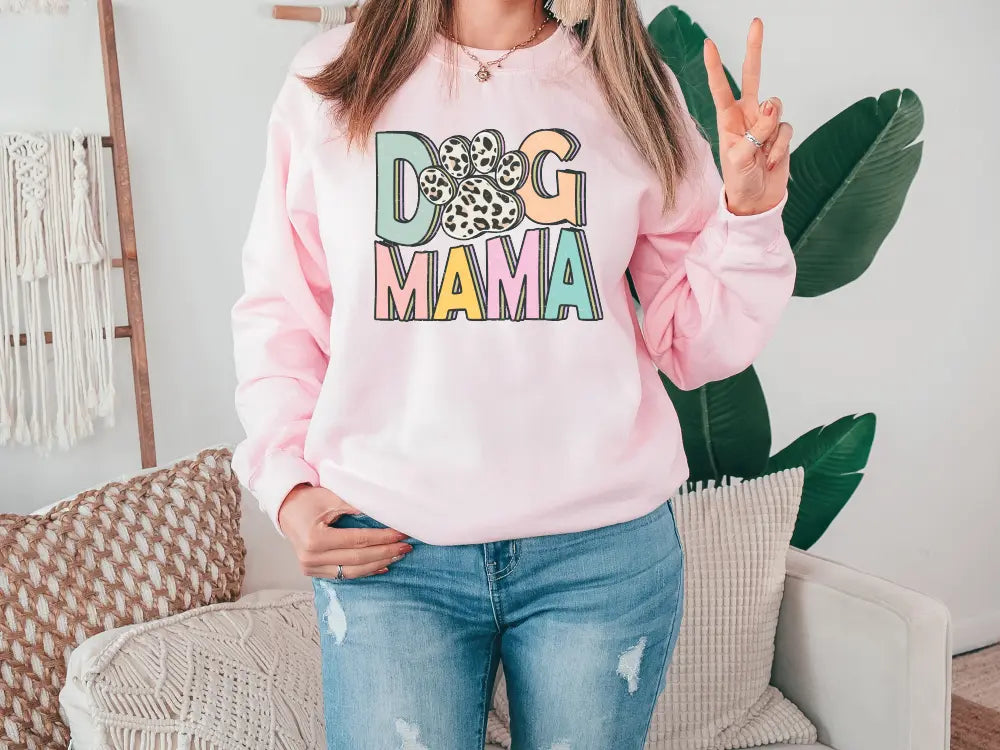 a woman wearing a pink dog mama sweatshirt