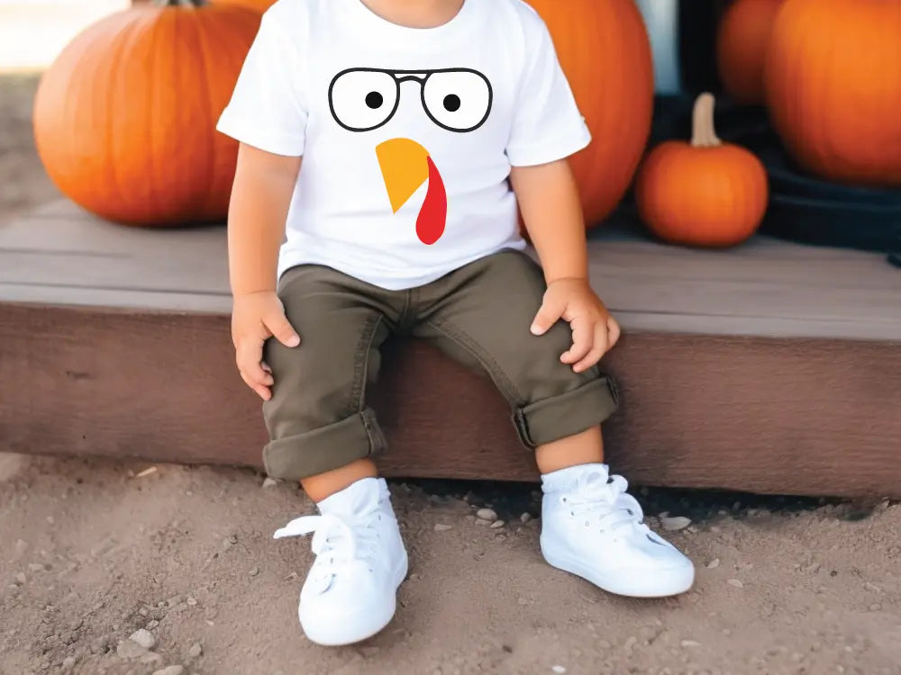 a little boy sitting in front of some pumpkins