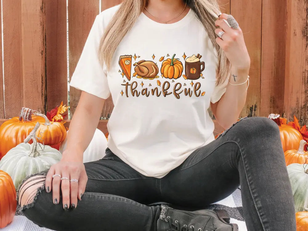 a woman sitting on the ground in front of pumpkins
