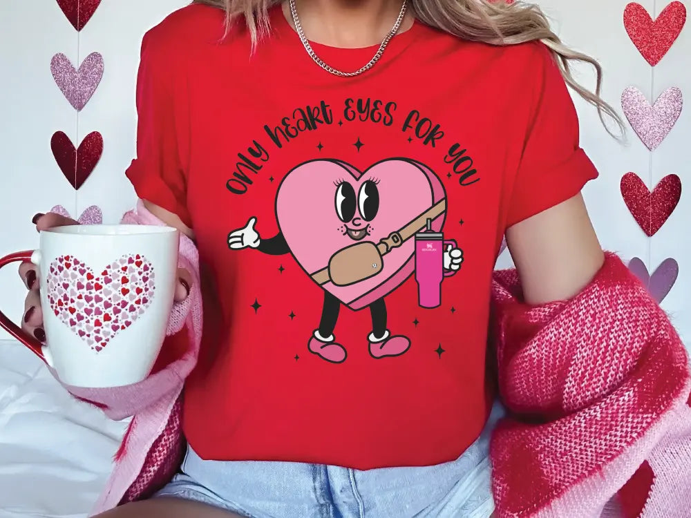 a woman in a red shirt holding a coffee mug
