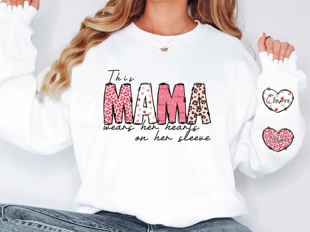 a woman wearing a white shirt with the word mama on it