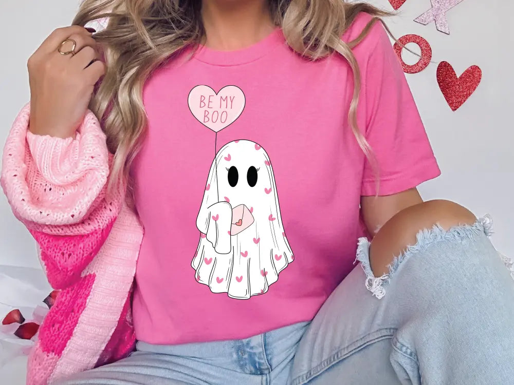 a woman wearing a pink shirt with a ghost on it