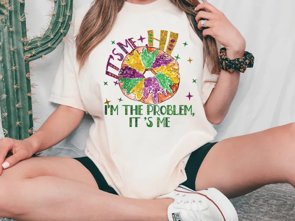 a woman wearing a t - shirt that says i'm the problem, it