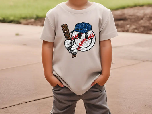 a young boy is holding a baseball bat