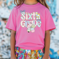 a little girl wearing a pink shirt with the words sixth grade on it