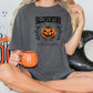 a woman sitting on a bed holding a pumpkin mug