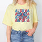 a woman wearing a yellow america tee shirt