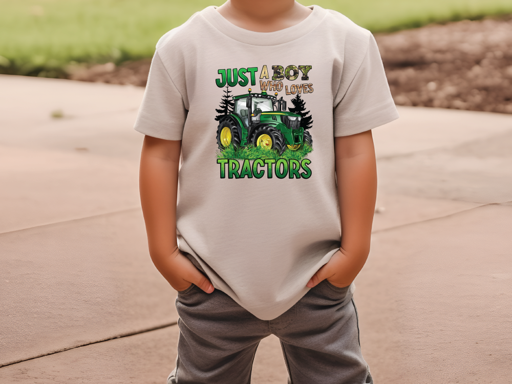 a young boy wearing a t - shirt that says just a boy who loves tractors