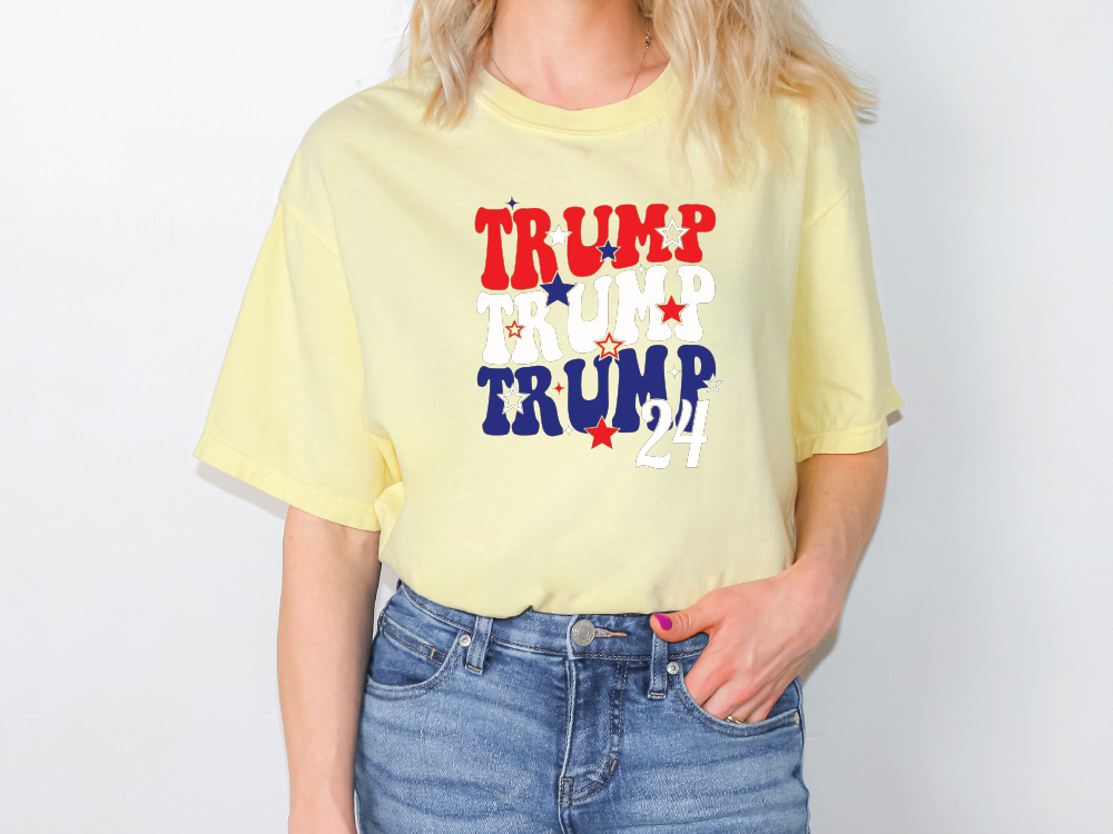 a woman wearing a yellow shirt with the words trump on it