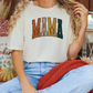 a woman sitting on a couch wearing a shirt that says mama