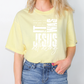 A woman wearing a yellow t-shirt with the text "It was all along" printed on it.