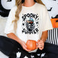 a woman sitting on a bed holding a pumpkin