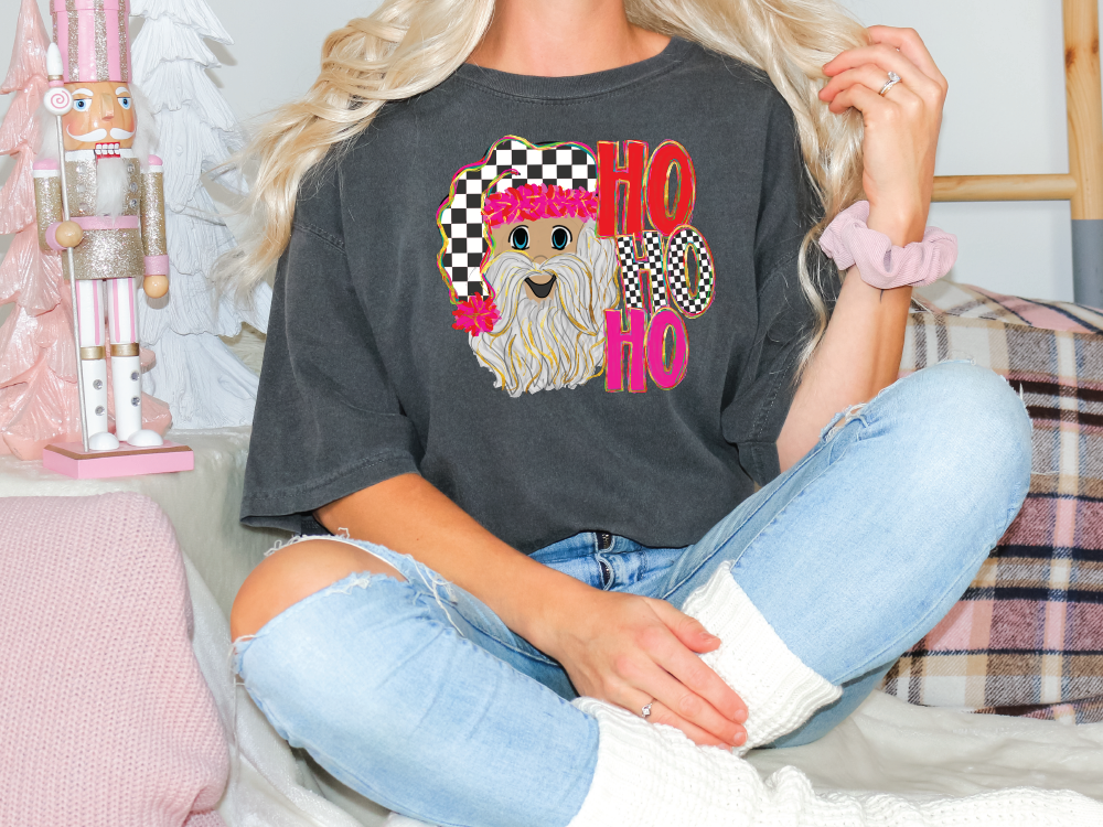 a blonde woman sitting on a bed wearing a shirt with a dog on it