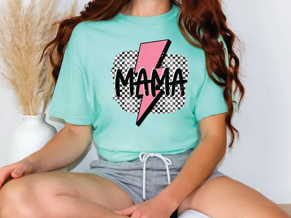 a woman sitting on a chair wearing a t - shirt with a lightning bolt on