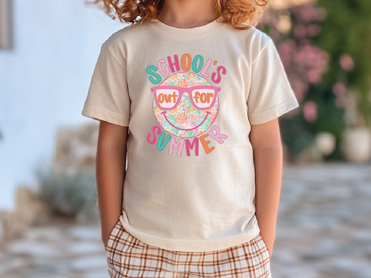 A child wearing a white t-shirt with a colorful graphic design that says "School's out for summer" and sunglasses.