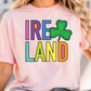 A woman wearing a pink t-shirt with the text "IRELAND" and a green shamrock graphic printed on it.