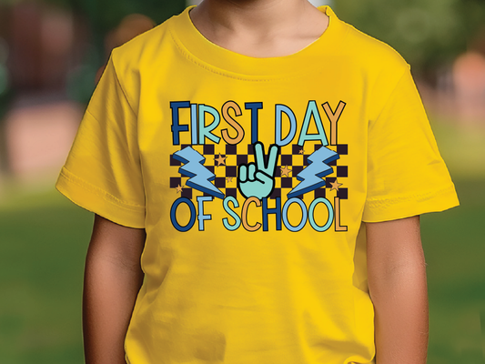 a young boy wearing a yellow shirt that says first day of school