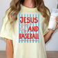 A woman wearing a yellow t-shirt with a graphic design that says "JESUS AND BASEBALL run the bases not before you".